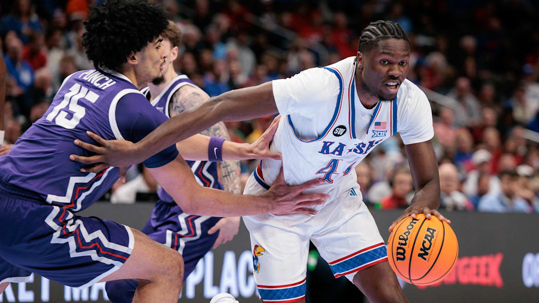 Mar 12, 2026; Kansas City, MO, USA; Kansas Jayhawks forward Flory Bidunga (40) drives to the basket around TCU Horned Frogs forward David Punch (15) during the first half at T-Mobile Center. Mandatory Credit: William Purnell-Imagn Images