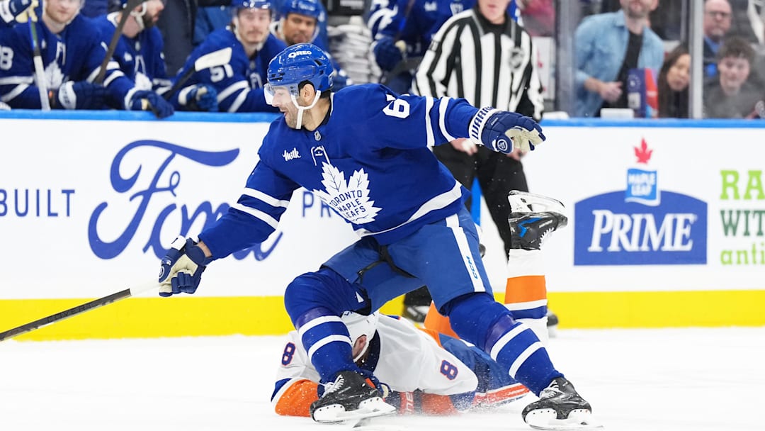 Dec 31, 2024; Toronto, Ontario, CAN; Toronto Maple Leafs left wing Max Pacioretty (67) battles with New York Islanders defenseman Noah Dobson (8) during the third period at the Scotiabank Arena. Mandatory Credit: Nick Turchiaro-Imagn Images