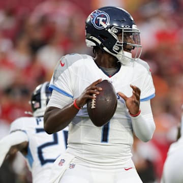 Aug 9, 2025; Tampa, Florida, USA; Tennessee Titans quarterback Cameron Ward (1) drops back to pass against the Tampa Bay Buccaneers in the first quarter during a preseason game at Raymond James Stadium. Mandatory Credit: Nathan Ray Seebeck-Imagn Images