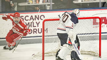 Feb 25, 2025; Storrs, CT, USA; Boston University forward Cole Eiserman (34) scores against UConn goaltender Tyler Muszelik (30) in a shoot-out after the third period at Toscano Family Ice Forum. Mandatory Credit: David Butler II-Imagn Images