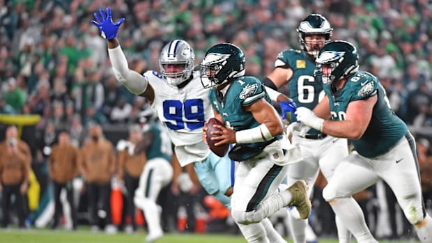 Philadelphia Eagles quarterback Jalen Hurts (1) scrambles away from Dallas Cowboys defensive end Chauncey Golston 