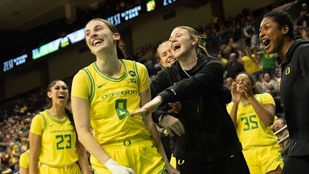 Oregon’s Elisa Mevius, center, celebrates a layup and foul against Washington with teammates during the second half at Matthe