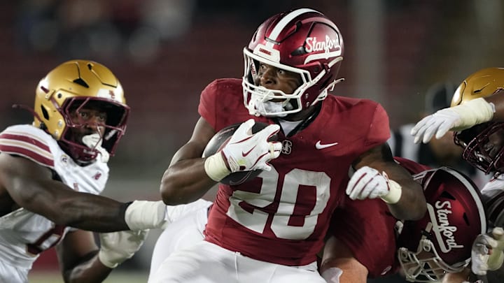 Sep 13, 2025; Stanford, California, USA; Stanford Cardinal running back Micah Ford (20) carries the ball against the Boston College Eagles during the fourth quarter at Stanford Stadium. Mandatory Credit: Darren Yamashita-Imagn Images