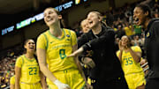 Oregon’s Elisa Mevius, center, celebrates a layup and foul against Washington with teammates during the second half at Matthew Knight Arena.