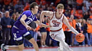 Jan 26, 2025; Champaign, Illinois, USA;  Illinois Fighting Illini guard Kasparas Jakucionis (32) drives the ball past Northwestern Wildcats guard Angelo Ciaravino (44) during the first half at State Farm Center. Mandatory Credit: Ron Johnson-Imagn Images
