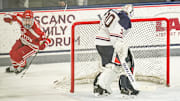 Feb 25, 2025; Storrs, CT, USA; Boston University forward Cole Eiserman (34) scores against UConn goaltender Tyler Muszelik (30) in a shoot-out after the third period at Toscano Family Ice Forum. Mandatory Credit: David Butler II-Imagn Images