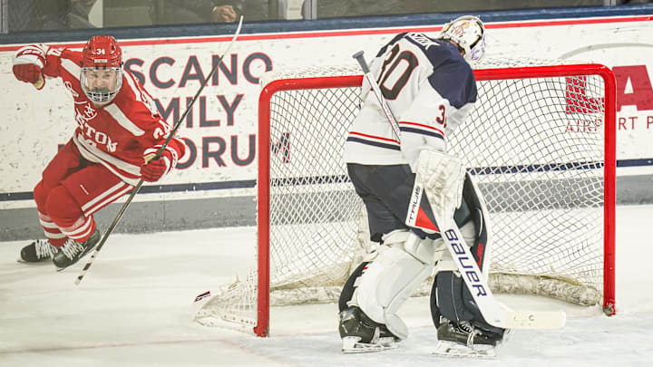 Feb 25, 2025; Storrs, CT, USA; Boston University forward Cole Eiserman (34) scores against UConn goaltender Tyler Muszelik (30) in a shoot-out after the third period at Toscano Family Ice Forum. Mandatory Credit: David Butler II-Imagn Images