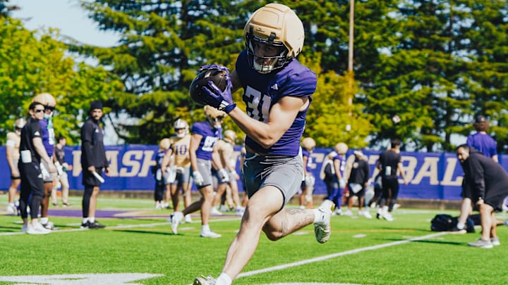 Luke Luchini makes a spring football catch on the East field. Luke Luchini makes a spring football catch on the East field.