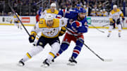 Mar 2, 2025; New York, New York, USA; Nashville Predators center Ryan O'Reilly (90) and New York Rangers defenseman Calvin de Haan (44) fight for position during the first period at Madison Square Garden. Mandatory Credit: Brad Penner-Imagn Images