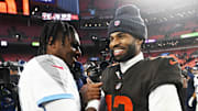 Dec 7, 2025; Cleveland, Ohio, USA; Cleveland Browns quarterback Shedeur Sanders (12) shakes hands with Tennessee Titans quarterback Cam Ward (1) after the game at Huntington Bank Field. Mandatory Credit: Ken Blaze-Imagn Images