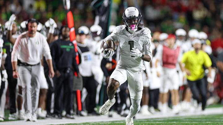 Oct 18, 2025; Piscataway, New Jersey, USA;  Oregon Ducks wide receiver Dakorien Moore (1) gains yards after catch during the first half against the Rutgers Scarlet Knights at SHI Stadium. Mandatory Credit: Vincent Carchietta-Imagn Images