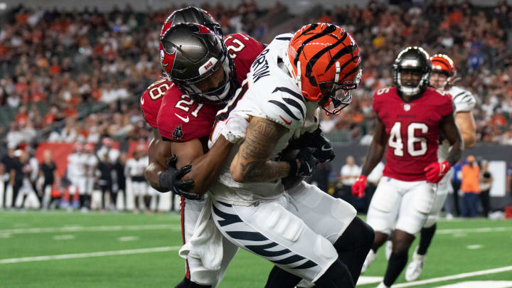 Tampa Bay Buccaneers corner back Andrew Hayes (21) tackles Cincinnati Bengals wide receiver Jermaine Burton (81) in the fourth quarter of the NFL preseason game at Paycor Stadium in Cincinnati on Saturday, August 10, 2024.