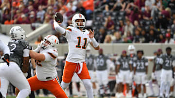 Nov 22, 2025; Blacksburg, Virginia, USA; Miami (FL) Hurricanes quarterback Carson Beck (11) throws a pass against the Virginia Tech Hokies during the first quarter at Lane Stadium. Mandatory Credit: Brian Bishop-Imagn Images