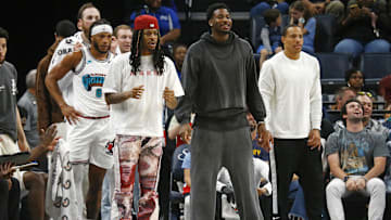Apr 13, 2025; Memphis, Tennessee, USA; Memphis Grizzlies guard Ja Morant (left), forward Jaren Jackson Jr. (middle) and guard Desmond Bane (22) look on from the bench area during the second quarter against the Dallas Mavericks at FedExForum. Mandatory Credit: Petre Thomas-Imagn Images