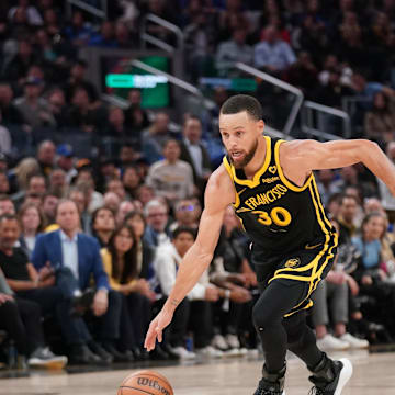 Mar 6, 2024; San Francisco, California, USA; Golden State Warriors guard Stephen Curry (30) dribbles past Milwaukee Bucks forward Giannis Antetokounmpo (34) in the third quarter at the Chase Center. Mandatory Credit: Cary Edmondson-Imagn Images