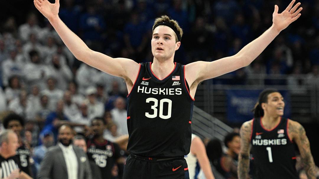 Feb 11, 2025; Omaha, Nebraska, USA;  Connecticut Huskies forward Liam McNeeley (30) celebrates a basket against the Creighton Bluejays during the second half at CHI Health Center Omaha. Mandatory Credit: Steven Branscombe-Imagn Images