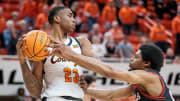 Mar 5, 2024; Stillwater, Oklahoma, USA; Oklahoma State Cowboys center Brandon Garrison (23) looks to pass around Texas Tech Red Raiders guard Kerwin Walton (24) during the first half at Gallagher-Iba Arena. Mandatory Credit: William Purnell-USA TODAY Sports