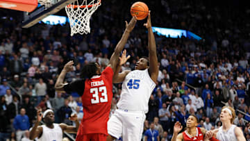 Fousseyni Traore takes a shot at the rim against the outstretched arms of the Texas Tech defense.