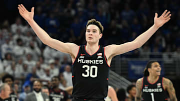 Feb 11, 2025; Omaha, Nebraska, USA;  Connecticut Huskies forward Liam McNeeley (30) celebrates a basket against the Creighton Bluejays during the second half at CHI Health Center Omaha. Mandatory Credit: Steven Branscombe-Imagn Images