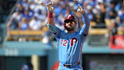 Oct 9, 2025; Los Angeles, California, USA; Philadelphia Phillies left fielder Kyle Schwarber (12) reacts after a double in the first inning against the Los Angeles Dodgers during game four of the NLDS round for the 2025 MLB playoffs at Dodger Stadium. Mandatory Credit: Jayne Kamin-Oncea-Imagn Images