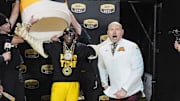 Jan 3, 2025; Charlotte, NC, USA; Flavor Flav surprises Minnesota Golden Gophers head coach P.J. Fleck and his team after their win over Virginia Tech Hokies at  the Duke’s Mayo Bowl at Bank of America Stadium. Mandatory Credit: Jim Dedmon-Imagn Images