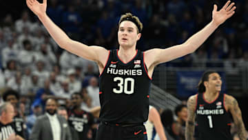 Feb 11, 2025; Omaha, Nebraska, USA;  Connecticut Huskies forward Liam McNeeley (30) celebrates a basket against the Creighton Bluejays during the second half at CHI Health Center Omaha. Mandatory Credit: Steven Branscombe-Imagn Images