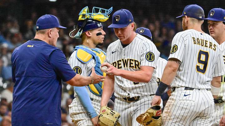 Sep 12, 2026; Milwaukee, Wisconsin, USA;  Milwaukee Brewers pitcher Kyle Harrison (52) hands the ball to manager Pat Murphy during a pitching change in the eighth inning against the Cincinnati Reds at American Family Field.  Mandatory Credit: Benny Sieu-Imagn Images
