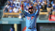 Oct 9, 2025; Los Angeles, California, USA; Philadelphia Phillies left fielder Kyle Schwarber (12) reacts after a double in the first inning against the Los Angeles Dodgers during game four of the NLDS round for the 2025 MLB playoffs at Dodger Stadium. Mandatory Credit: Jayne Kamin-Oncea-Imagn Images