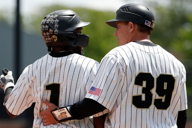 Purdue Boilermakers outfielder Mike Bolton Jr. (1) talks to Purdue head coach Greg Goff during the NCAA baseball game