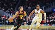 Nov 29, 2024; Atlanta, Georgia, USA; Atlanta Hawks guard Trae Young (11) dribbles the ball past Cleveland Cavaliers guard Donovan Mitchell (45) during the first quarter at State Farm Arena. Mandatory Credit: Jordan Godfree-Imagn Images