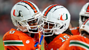 Nov 8, 2025; Miami Gardens, Florida, USA; Miami Hurricanes wide receiver Keelan Marion (0) celebrates with wide receiver Daylyn Upshaw (15) after a touchdown pass against the Syracuse Orange during the third quarter at Hard Rock Stadium. Mandatory Credit: Jeff Romance-Imagn Images