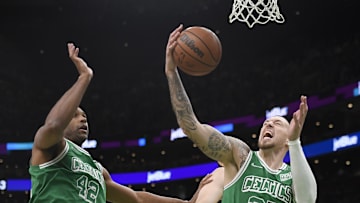 Apr 1, 2022; Boston, Massachusetts, USA; Boston Celtics center Daniel Theis (27) grabs a rebound while center Al Horford (42) looks on during the first half against the Indiana Pacers at TD Garden. Mandatory Credit: Bob DeChiara-Imagn Images