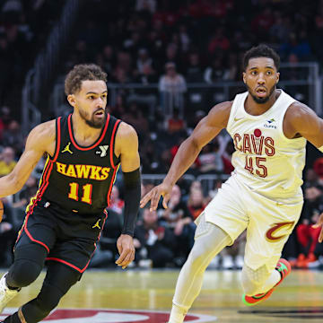 Nov 29, 2024; Atlanta, Georgia, USA; Atlanta Hawks guard Trae Young (11) dribbles the ball past Cleveland Cavaliers guard Donovan Mitchell (45) during the first quarter at State Farm Arena. Mandatory Credit: Jordan Godfree-Imagn Images