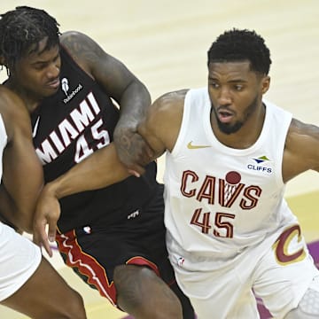 Apr 23, 2025; Cleveland, Ohio, USA; Cleveland Cavaliers forward Evan Mobley (4) sets a pick as guard Donovan Mitchell (45) dribbles around Miami Heat guard Davion Mitchell (45) in the fourth quarter of game two of the first round of the 2025 NBA Playoffs at Rocket Arena. Mandatory Credit: David Richard-Imagn Images