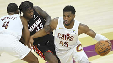 Apr 23, 2025; Cleveland, Ohio, USA; Cleveland Cavaliers forward Evan Mobley (4) sets a pick as guard Donovan Mitchell (45) dribbles around Miami Heat guard Davion Mitchell (45) in the fourth quarter of game two of the first round of the 2025 NBA Playoffs at Rocket Arena. Mandatory Credit: David Richard-Imagn Images