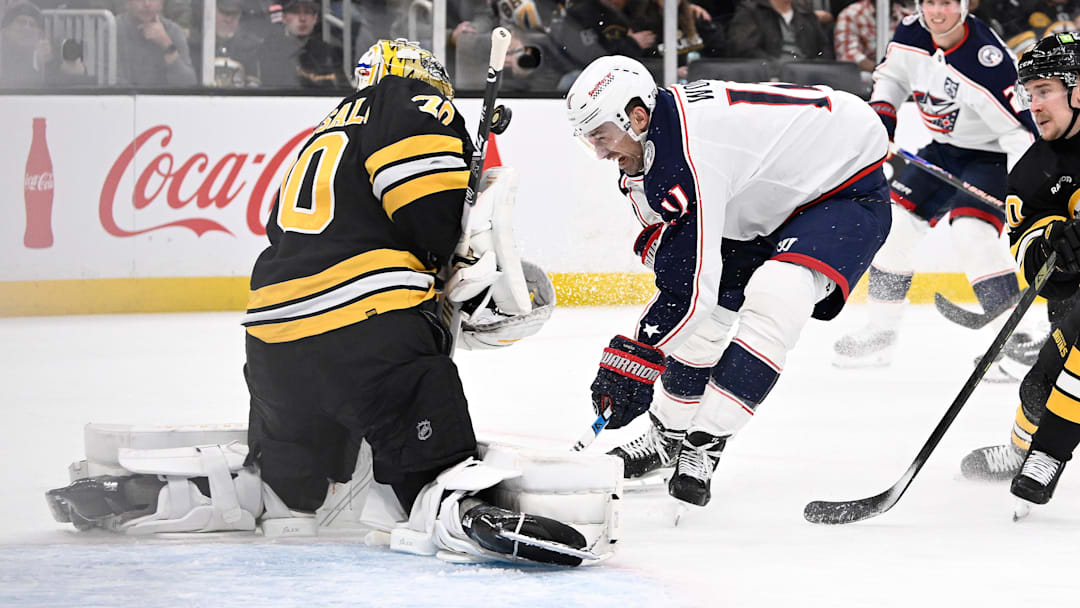 Blue Jackets forward Miles Wood crashes towards Bruins goaltender Joonas Korpisalo. Blue Jackets forward Miles Wood crashes towards Bruins goaltender Joonas Korpisalo.