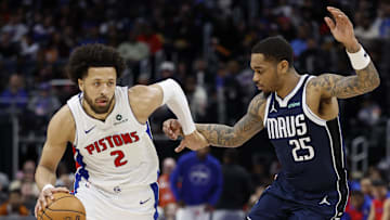 Jan 31, 2025; Detroit, Michigan, USA;  Detroit Pistons guard Cade Cunningham (2) dribbles defended by Dallas Mavericks forward P.J. Washington (25) in the second half at Little Caesars Arena. Mandatory Credit: Rick Osentoski-Imagn Images