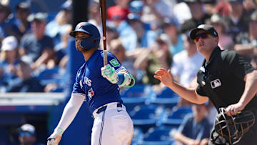 Mar 2, 2025: Toronto Blue Jays shortstop Bo Bichette (11) hits a home run against the Philadelphia Phillies in the third inning during spring training at TD Ballpark. 