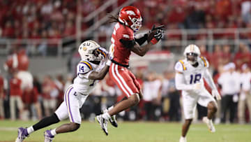 Oct 19, 2024; Fayetteville, Arkansas, USA; Arkansas Razorbacks wide receiver Tyrone Broken (5) attempts a catch as LSU Tigers cornerback Zy Alexander (14) defends at Donald W. Reynolds Razorback Stadium. Mandatory Credit: Nelson Chenault-Imagn Images
