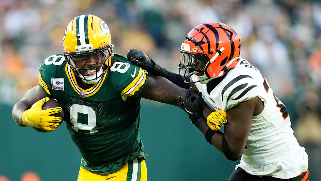 Oct 12, 2025; Green Bay, Wisconsin, USA; Green Bay Packers running back Josh Jacobs (8) runs the ball against Cincinnati Bengals safety Jordan Battle (27) in the second half at Lambeau Field. Mandatory Credit: Kayla Wolf-Imagn Images