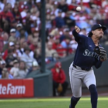 Seattle Mariners first baseman Josh Rojas (4) throws to first base for an out against the St. Louis Cardinals in the first inning at Busch Stadium in 2024.