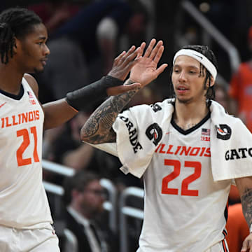 Mar 13, 2025; Indianapolis, IN, USA; Illinois Fighting Illini forward Morez Johnson Jr. (21) high-fives Illinois Fighting Illini guard Tre White (22) during the second half against the Iowa Hawkeyes at Gainbridge Fieldhouse. Mandatory Credit: Robert Goddin-Imagn Images