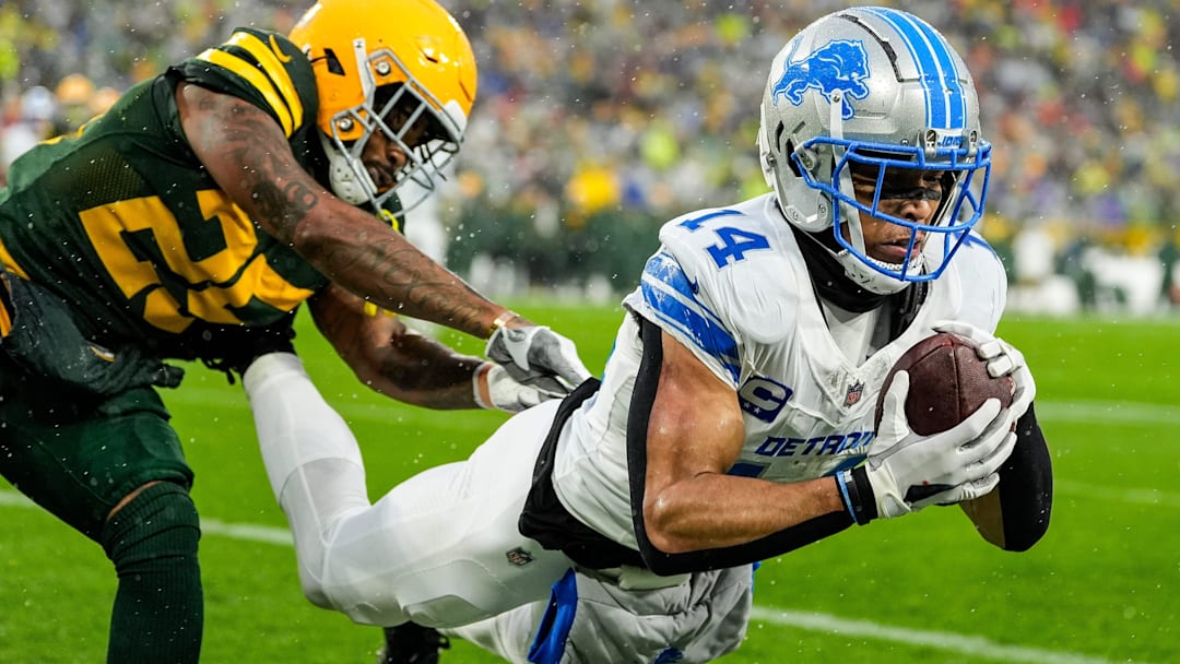 Detroit Lions wide receiver Amon-Ra St. Brown (14) makes a catch for a touchdown against Green Bay Packers cornerback Keisean Nixon (25) during the first half at Lambeau Field in Green Bay, Wis. on Sunday, Nov. 3, 2024.