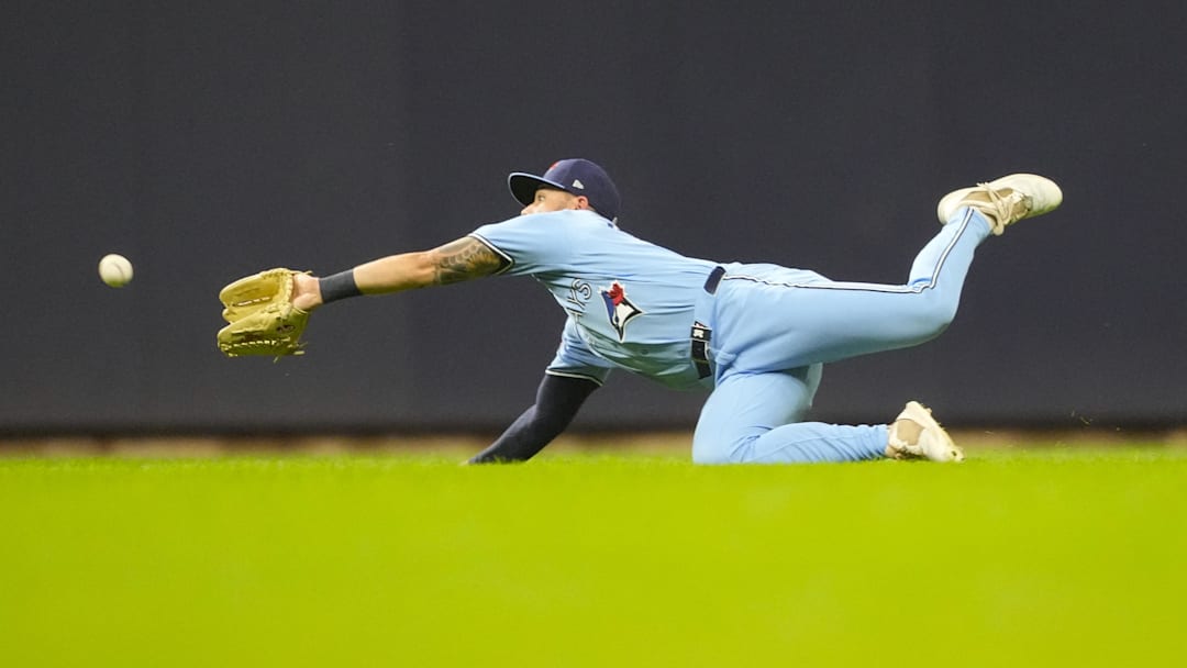 Apr 14, 2026; Milwaukee, Wisconsin, USA;  Toronto Blue Jays right fielder Nathan Lukes (38) dives for the ball hit by Milwaukee Brewers right fielder Sal Frelick (10) (not pictured) during the third inning at American Family Field. Mandatory Credit: Jeff Hanisch-Imagn Images