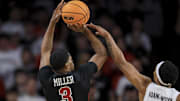 Feb 22, 2023; Cincinnati, Ohio, USA;  Temple Owls guard Hysier Miller (3) attempts a three-point basket against Cincinnati Bearcats guard Mika Adams-Woods (3) in the first half at Fifth Third Arena. Mandatory Credit: Aaron Doster-Imagn Images