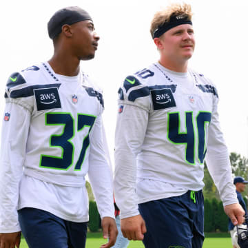 Jul 27, 2024; Renton, WA, USA; Seattle Seahawks cornerback Carlton Johnson (37) and linebacker Easton Gibbs (40) walk off the field after training camp at Virginia Mason Athletic Center. Mandatory Credit: Steven Bisig-USA TODAY Sports