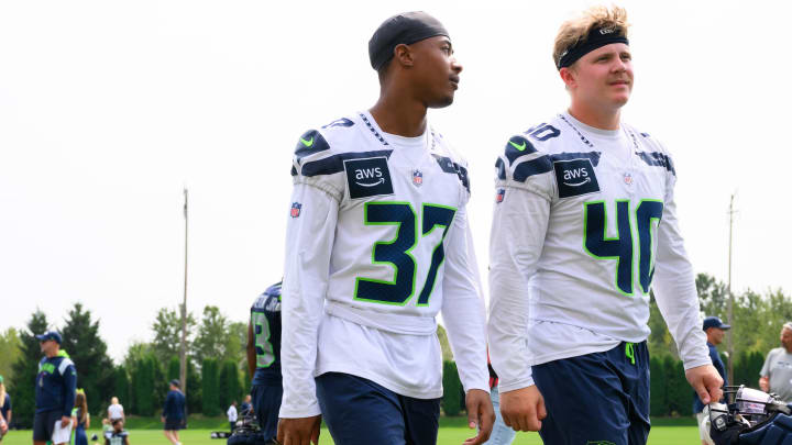 Jul 27, 2024; Renton, WA, USA; Seattle Seahawks cornerback Carlton Johnson (37) and linebacker Easton Gibbs (40) walk off the field after training camp at Virginia Mason Athletic Center. Mandatory Credit: Steven Bisig-USA TODAY Sports