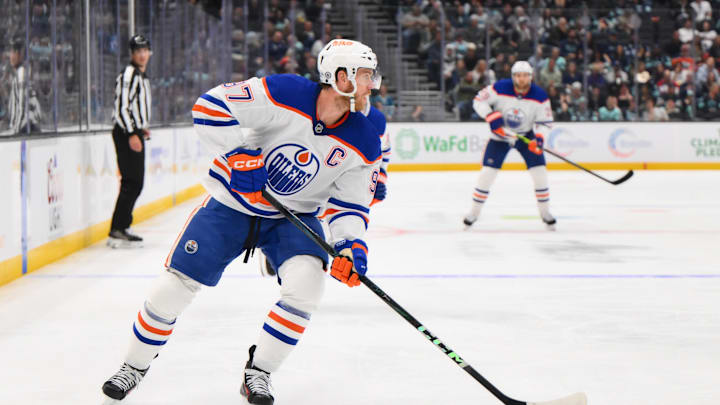 Oct 2, 2024; Seattle, Washington, USA; Edmonton Oilers center Connor McDavid (97) plays the puck during the second period against the Seattle Kraken at Climate Pledge Arena. Mandatory Credit: Steven Bisig-Imagn Images Oct 2, 2024; Seattle, Washington, USA; Edmonton Oilers center Connor McDavid (97) plays the puck during the second period against the Seattle Kraken at Climate Pledge Arena. Mandatory Credit: Steven Bisig-Imagn Images