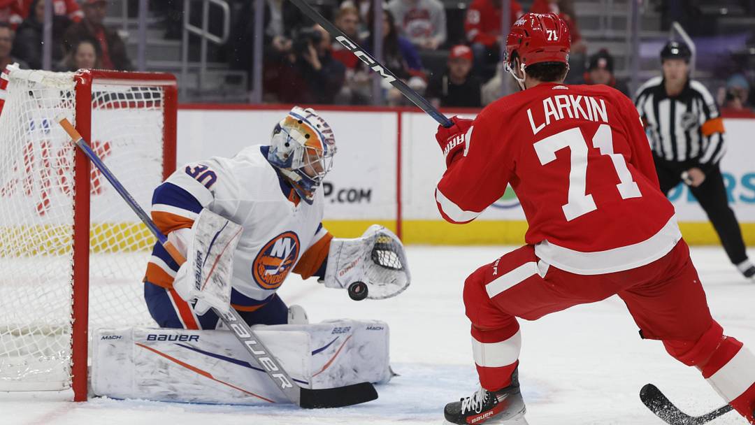 Feb 29, 2024; Detroit, Michigan, USA;  New York Islanders goaltender Ilya Sorokin (30) makes a save on Detroit Red Wings center Dylan Larkin (71) in the second period at Little Caesars Arena. Mandatory Credit: Rick Osentoski-Imagn Images