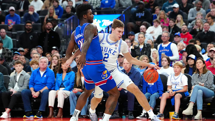 Duke Blue Devils forward Flagg dribbles against Kansas Jayhawks forward Adams Jr. during the first half at T-Mobile Arena. Duke Blue Devils forward Flagg dribbles against Kansas Jayhawks forward Adams Jr. during the first half at T-Mobile Arena.